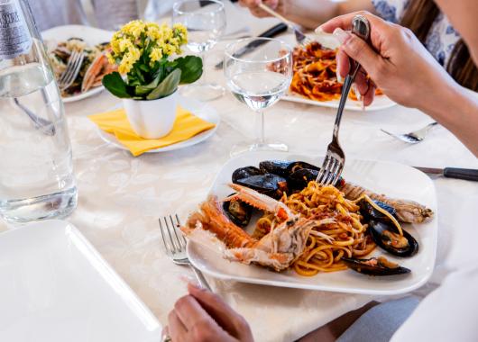 Seafood spaghetti dish on a set table.