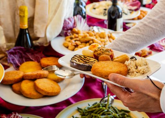 Buffet with assorted dishes and wine.