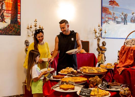 Family choosing desserts from a rich and varied buffet.