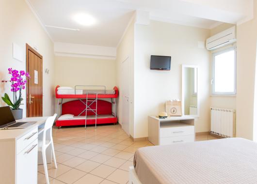 Modern room with bunk bed and desk.