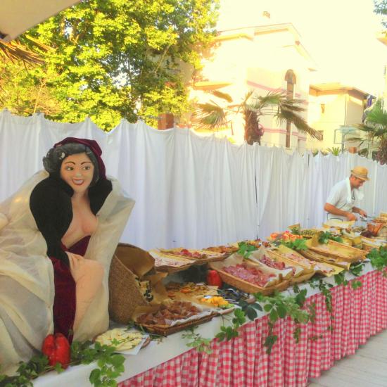 Buffet all'aperto con decorazioni e piatti vari.