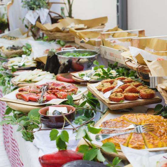 Buffet con piatti italiani, pane e verdure fresche.