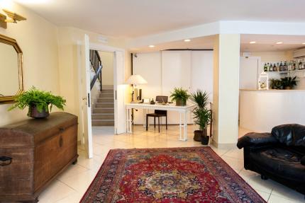 Elegant entrance with Persian rug and plants.