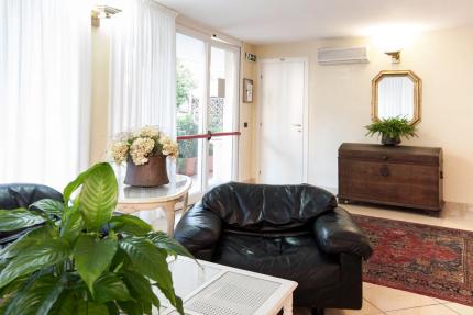 Elegant living room with leather sofa and plants.