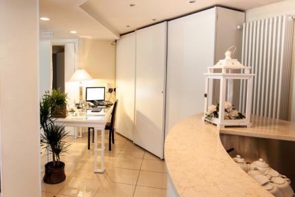 Modern office with desk, plants, and decorative lantern.