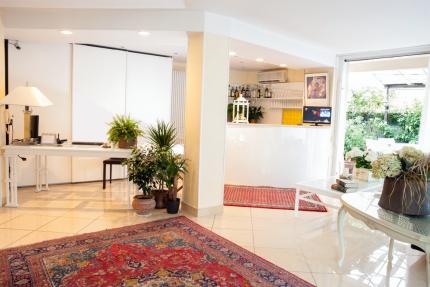 Elegant reception with plants and colorful rugs.