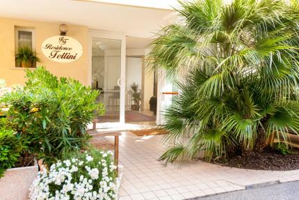 Entrance of Residence Fellini with plants and flowers.