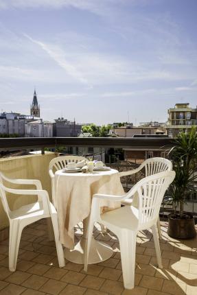 Terrace with set table and city view.