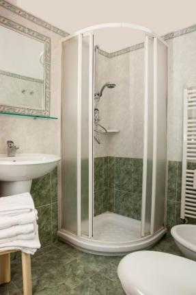 Bathroom with corner shower and sink.