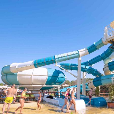 Water slides with people enjoying under the sun.
