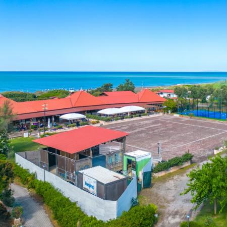 Sea view with playground and sports fields.
