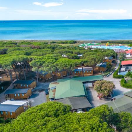 Sea view with bungalows, pool, and play area.