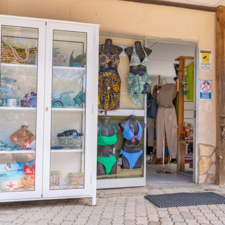 Summer clothing shop with colorful swimsuits and dresses.