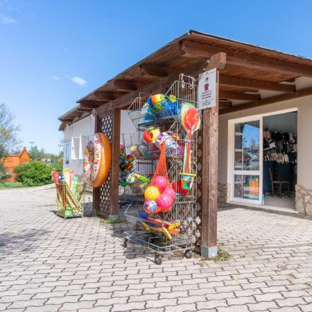 Summer shop with inflatables and deck chairs outside.