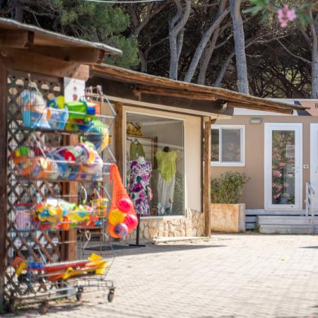 Beauty salon next to toy and clothing shop.