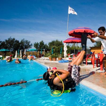 Scuba diving lesson in pool with instructor.