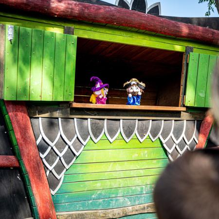 Outdoor puppet show featuring witches and pirates.