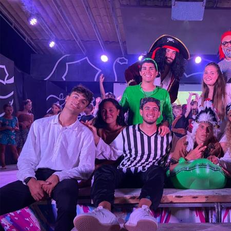 Costumed group on a lit stage, pirate theme.