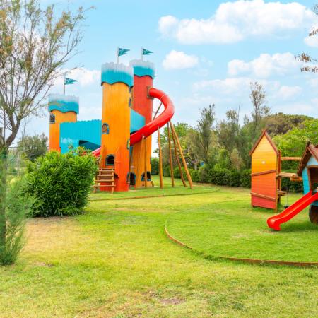 Colorful playground with slides and wooden structures.
