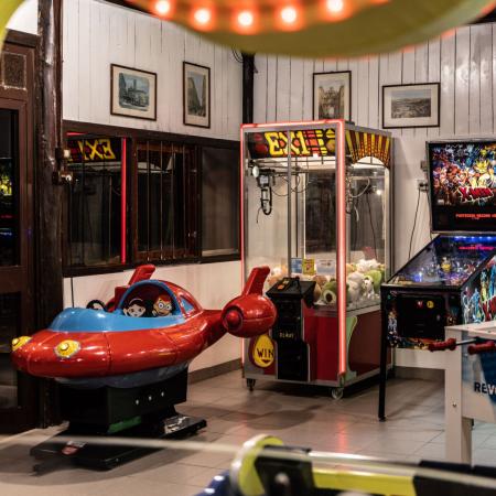 Arcade with pinball, foosball, and children's rides.