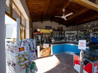 Bar with snacks, ice cream, and displayed trophies.