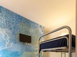Room with bunk beds, table, and blue decorative wall.