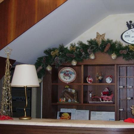 Reception decorated for Christmas with clock, garland, and tree.