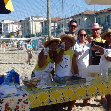 Group of people with cowboy hats on a beach.