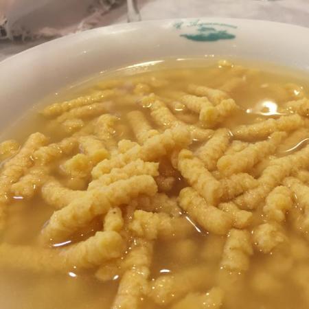 Soup with passatelli in broth, traditional Italian dish.