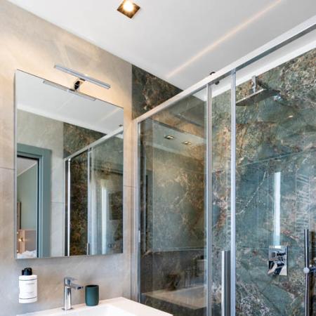 Modern, bright bathroom with a glass shower and elegant sink.