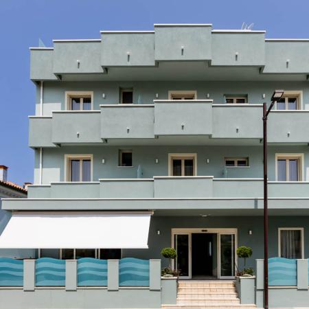 Modern blue building, clean lines, serene and bright atmosphere.