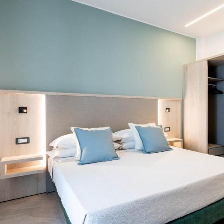 Modern, cozy room with double bed, wardrobe, and soothing tones.
