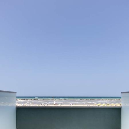 Terrace with sea view, clear sky, relaxing atmosphere.
