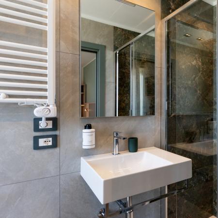 Modern bathroom with elegant shower and minimalist sink, luxurious ambiance.