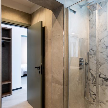 Elegant modern bathroom with marble shower, creating a relaxing and bright atmosphere.