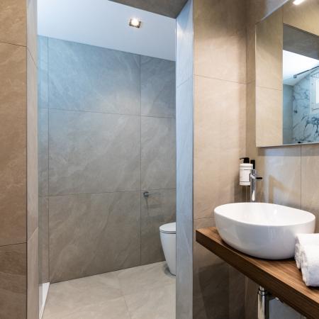 Elegant minimalist bathroom with modern sink and soft towels.
