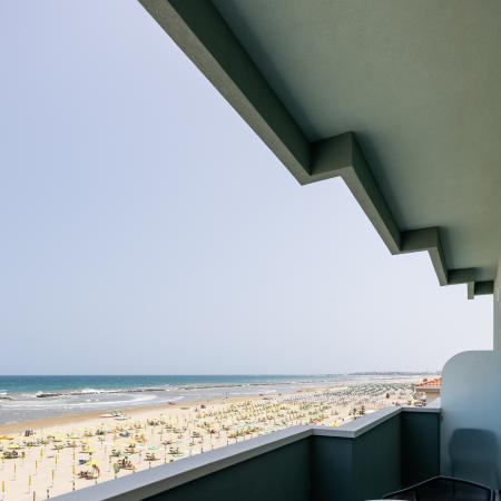 Breathtaking view of a crowded beach from a stylish balcony.