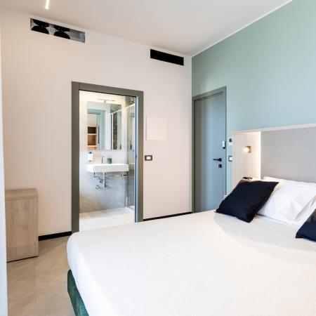 Bright room with a cozy bed and modern bathroom.