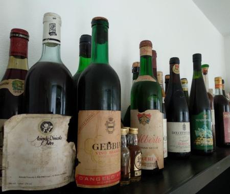 Collection of vintage wine bottles on a shelf.