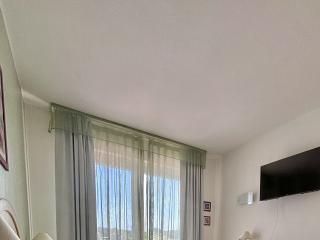 Bright bedroom with double bed and balcony.