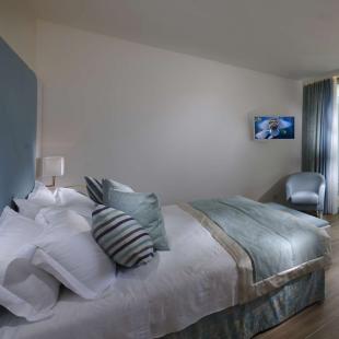 Modern room with sea view and balcony.