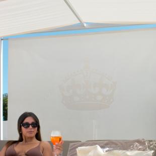 Woman in bikini with drink at Montecarlo Lifestyle Hotel.