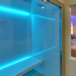 Modern room with blue lighting and stylish chairs.