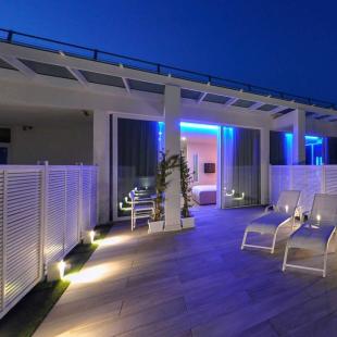 Modern terrace with jacuzzi and blue lights.