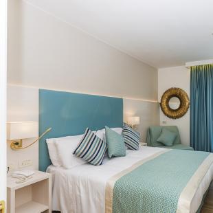 Modern room with double bed and TV.