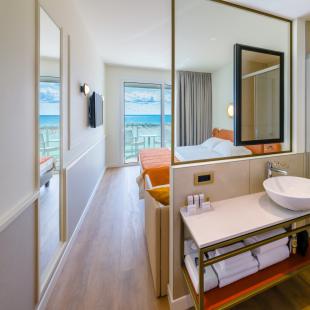 Modern room with sea view and elegant bathroom.