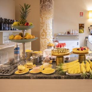 Buffet with desserts, fruit, and colorful drinks.
