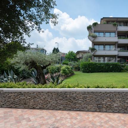 Modern building with a well-kept garden and decorative plants.