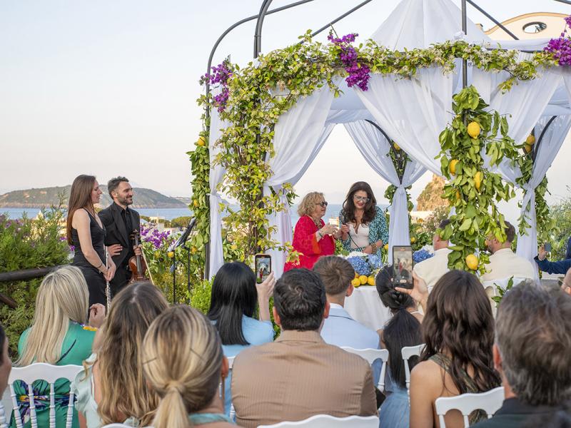 Outdoor ceremony with floral decorations and lemons.
