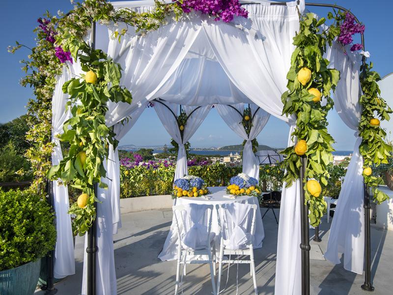 Gazebo decorated with flowers and lemons, panoramic view.